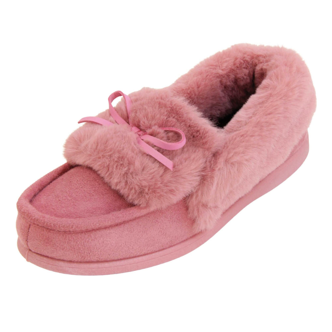 Pink moccasin slippers. Moccasin style slipper with pink faux suede upper and bow to the top. Pink faux fur collar, tongue and lining. Pink rubber sole. Left foot at an angle.