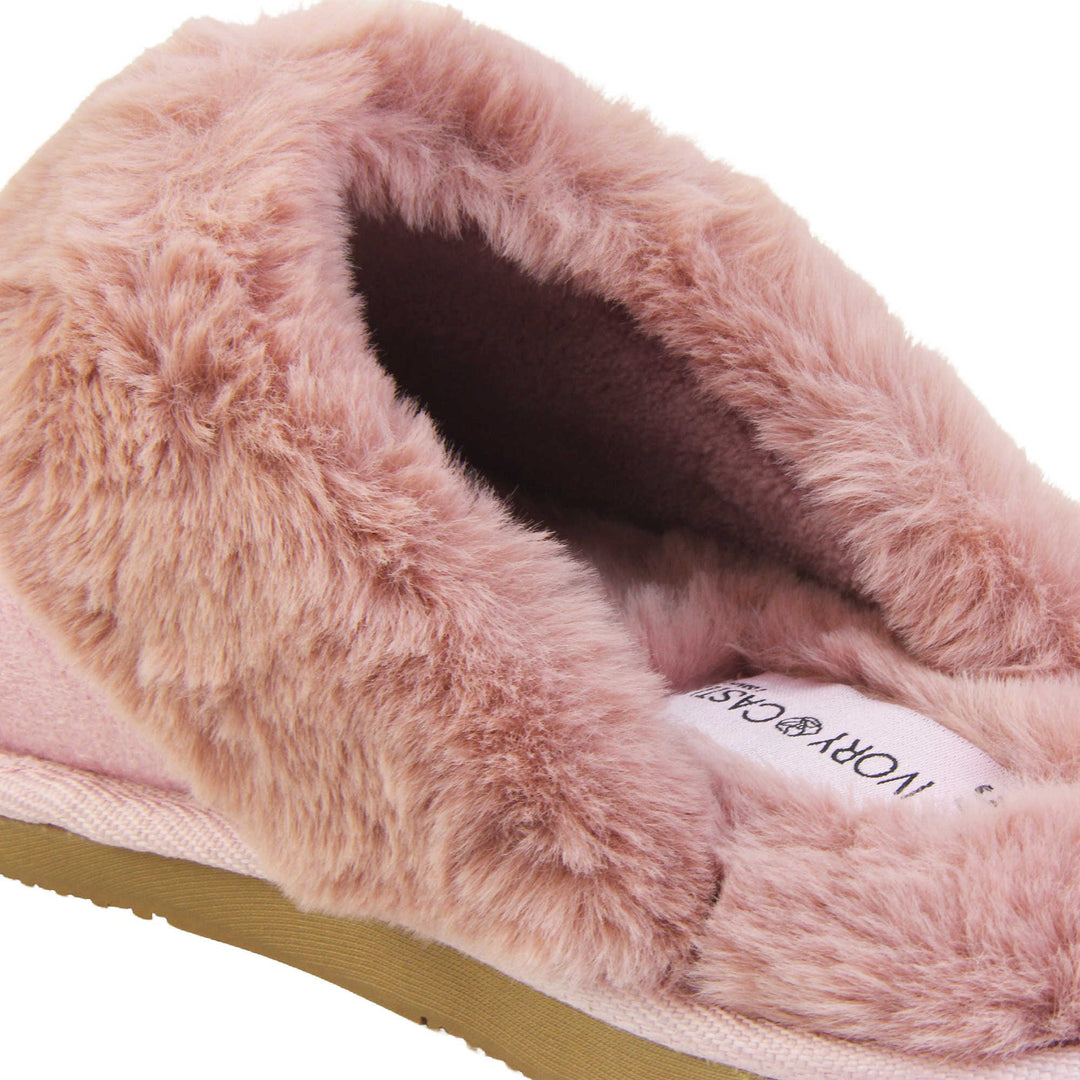 Pink Mule Slippers. Mule style slippers with pink faux suede uppers. Pink faux fur lining and collar. Firm pink outsole with grip on the bottom. Close up of the fluffy lining and collar.