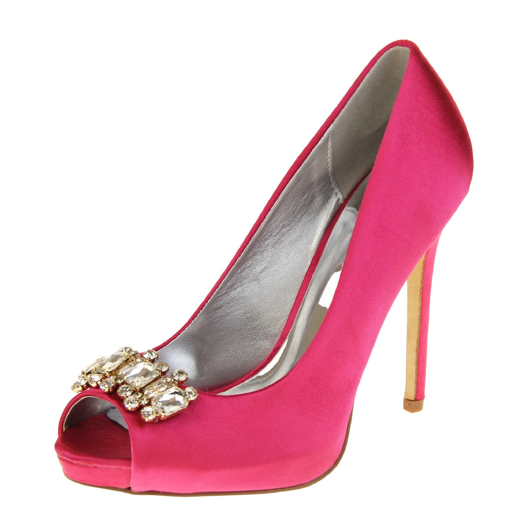 Pink satin wedding shoes. Classic women's peep toe high heels with a fuchsia satin upper. Metallic silver insole with Sabatine branding. Fuchsia satin stiletto heel with a cream sole. Diamante cluster detailing across the toes. Left foot at an angle.