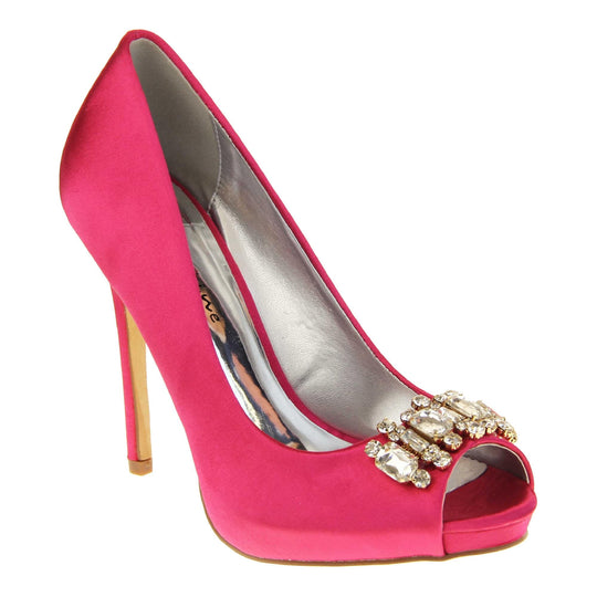 Pink satin wedding shoes. Classic women's peep toe high heels with a fuchsia satin upper. Metallic silver insole with Sabatine branding. Fuchsia satin stiletto heel with a cream sole. Diamante cluster detailing across the toes. Right foot at an angle.