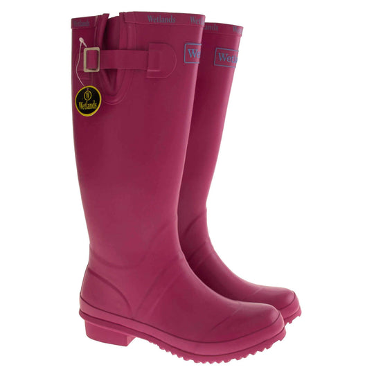 Pink wellington boots. Bright pink rubber waterproof wellington boots. Just below knee height. With a small heel and deep tread to the sole. Pink Wetlands Brand to the front of the boot near the top. Wetlands written in Lilac numerous times around the rim of the boot. Side strap with buckle to adjust the calf width. Textile lining to the inside of the boot. Both boots next to each other