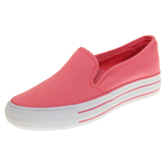 Platform pumps. Slip on plimsoll style shoes with a pink canvas upper. Pink elasticated gusset. White flat platform sole with two pink lines running around the middle. Left foot at an angle.