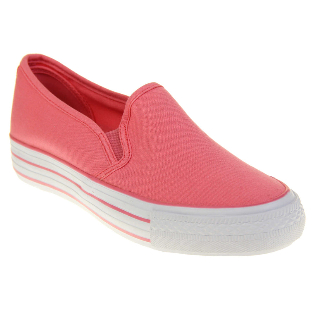 Platform pumps. Slip on plimsoll style shoes with a pink canvas upper. Pink elasticated gusset. White flat platform sole with two pink lines running around the middle. Right foot at an angle.