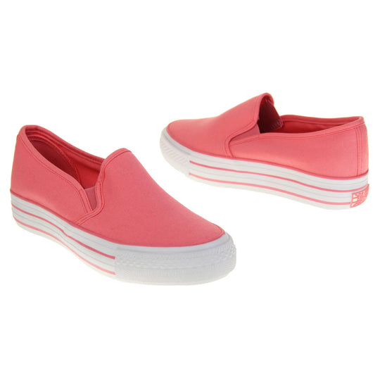 Platform pumps. Slip on plimsoll style shoes with a pink canvas upper. Pink elasticated gusset. White flat platform sole with two pink lines running around the middle. Both feet at an angle facing top to tail.