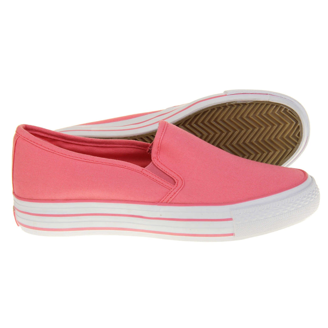 Platform pumps. Slip on plimsoll style shoes with a pink canvas upper. Pink elasticated gusset. White flat platform sole with two pink lines running around the middle. Both feet from a side profile with the left foot on its side behind the the right foot to show the sole.