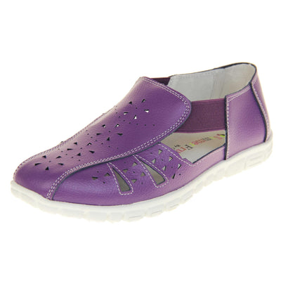 Purple wide fit shoes. Womens classic full foot sandal with a purple leather upper. Strappy sides with cut out designs along the side and centre straps. Purple elasticated straps joining the centre to the backs. White insole and leather lining. White sole with grip to the bottom. Left foot at an angle.
