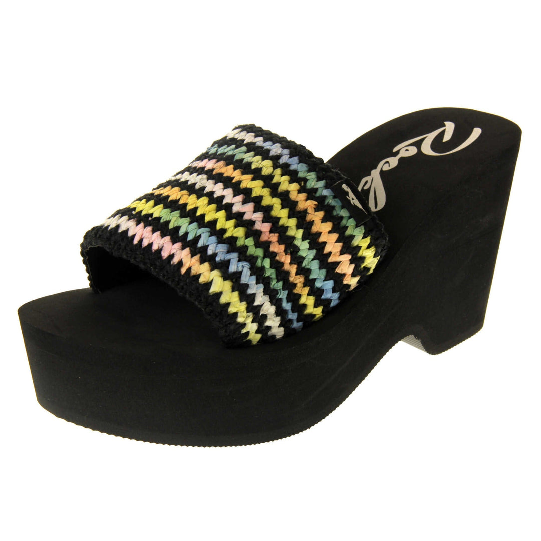 Womens Black Rocket Dog Sandals - Black foam sole and platform with a black hessian upper and a pastel rainbow zigzag design. Left foot at an angle.