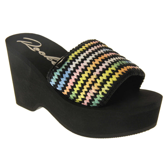 Womens Black Rocket Dog Sandals - Black foam sole and platform with a black hessian upper and a pastel rainbow zigzag design. Right foot at an angle.