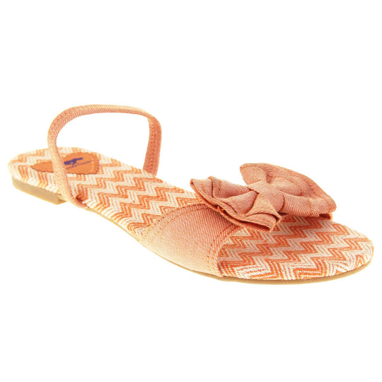 Rocket dog sandals. Classic womens slingback sandals with a orange coral coloured textile straps. orange and cream zig zag print insoles with an orange heart to the bag with Rocket dog logo. Thin beige outsole with a tiny heel. Right foot at an angle.