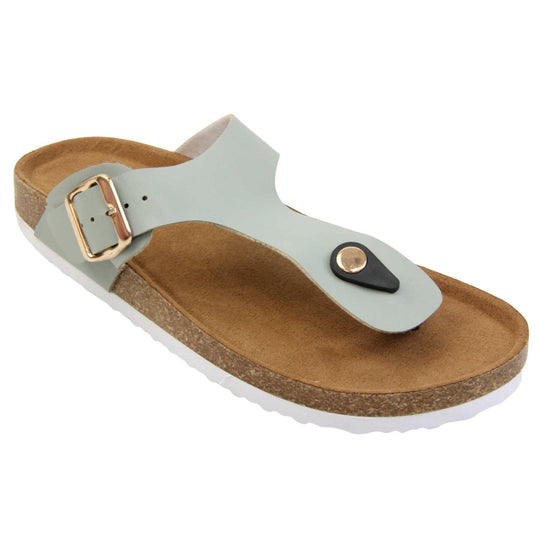 Sage flip flops. Sage green faux leather strap with toe post to the front and gold buckle to the outside. Soft tan faux suede footbed with cork effect outsole and white sole. Right foot at an angle.