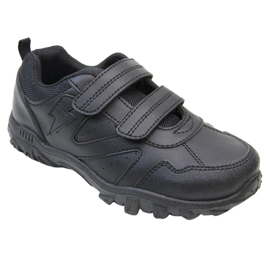 School trainers boy. Black faux leather trainers with zig zag detailing along the sides and a lightning bolt near the ankle. Two black touch fasten straps across the foot with a black textile lining. Chunky black soles. Right foot at an angle.