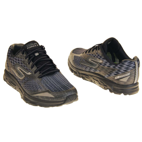 Skechers go run mens. Black mesh upper. Black and grey laces and black textile lining. Grey and white Skechers logo to the side and chunky black outsole with grip. Both feet at a slight angle facing top to tail.