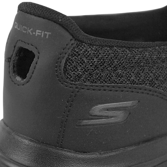 Skechers go walk five. Mens loafer style shoes with a trainer sole. Black woven mesh upper. Skechers S logo to the back. Black sole with grip to the bottom. Black textile lining.  Close up of the shoe to show the back of it and Skechers detail to the back.