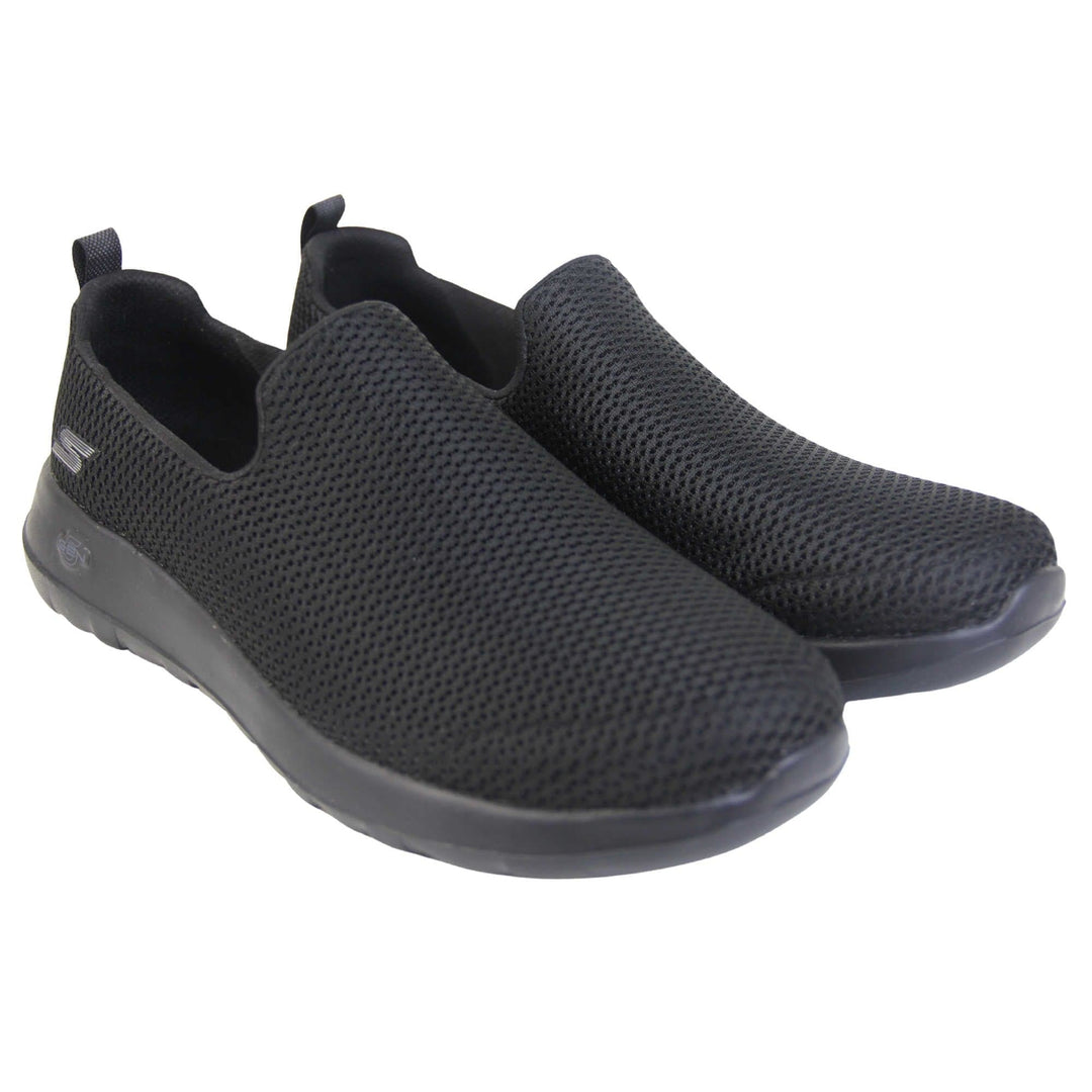 Skechers go walk max. Mens loafer style shoes with a trainer sole. Black woven mesh upper. Skechers S logo to the back. Black sole with grip to the bottom. Black textile lining. Both feet together from an angle.