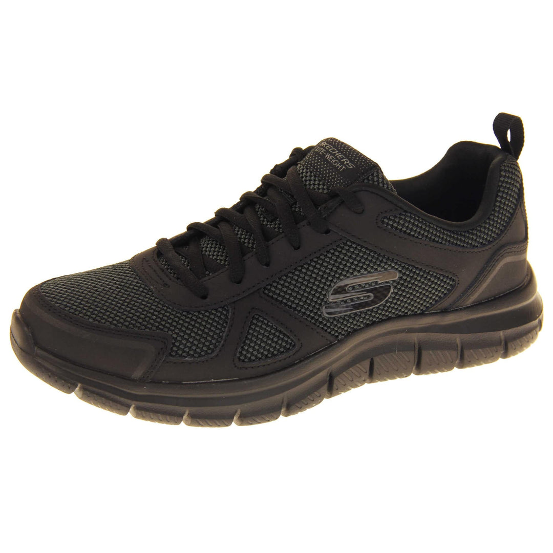 Skecher light weight. Black mesh and leather upper with black laces and black textile lining. Grey and black Skechers logo to the side and chunky black outsole with grip. Left foot at an angle.