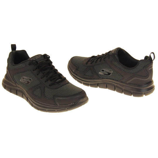 Skecher light weight. Black mesh and leather upper with black laces and black textile lining. Grey and black Skechers logo to the side and chunky black outsole with grip. Both feet at a slight angle facing top to tail.