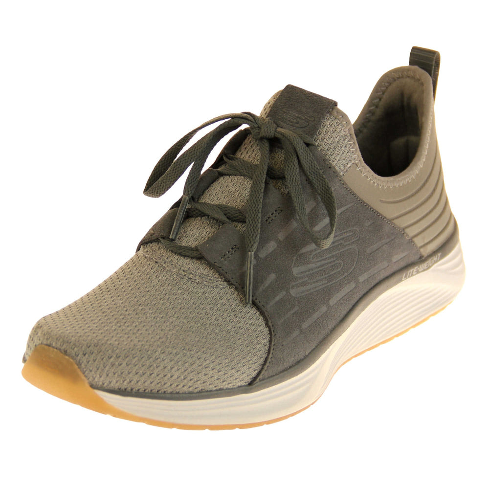 Skechers mens suede trainers. Grey woven mesh fabric upper with dark grey sport suede side overlay panels. With an embossed S skechers logo to the side. Dark grey laces and loop on the heel to help pull on. Chunky white outsole with beige base. Grey textile lining. Left foot at an angle.