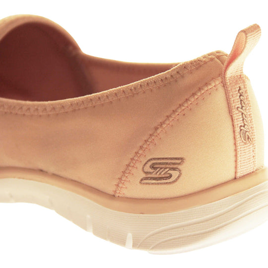 Skechers Shoes Pink. Rose gold lycra ladies flats. Front half of the shoe, toe to mid foot, is covered in pale pink rhinestones. Skechers logo and branding to the back of the shoe. White synthetic sole. Back of a shoe to show the branding and logo.