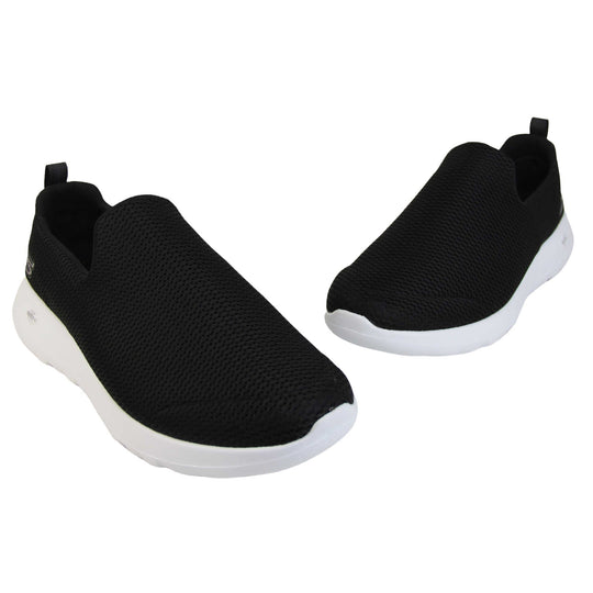 Skechers wide fit trainers. Mens loafer style trainers. Black woven mesh upper. Skechers S logo to the back. chunky white sole with grip to the bottom. Black textile lining. Both feet in a v shape with the toes in a point.