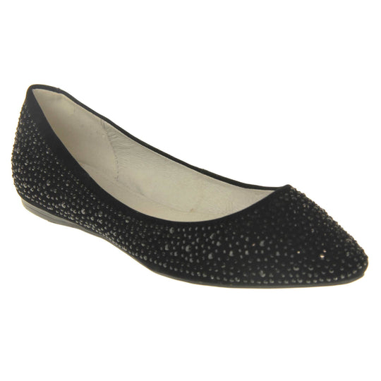 Sparkly shoes flat. Ballet style shoes with a black faux suede upper covered in black diamantes. Cream leather lining and black sole. Right foot at an angle.