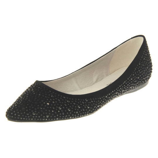 Sparkly shoes flat. Ballet style shoes with a black faux suede upper covered in black diamantes. Cream leather lining and black sole. Left foot at an angle.