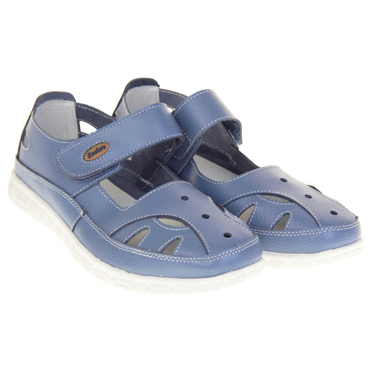 Comfy wide fit sandals. Mary Jane style shoes. Blue leather uppers with white stitching detail. Blue touch fasten strap over the foot with brown oval with Coolers branding on. Cut outs in the middle, edges and heel of the shoes. White sole with grip to the bottom. Both shoes together from an angle