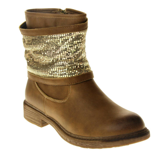 Tan sparkle ankle boots women. Biker style ankle boot with a tan faux leather upper. A thick band of shiny gold chainmail runs around the ankle. Zip fastening down the inside of the boot. Brown sole with a slight heel. Right foot at an angle.