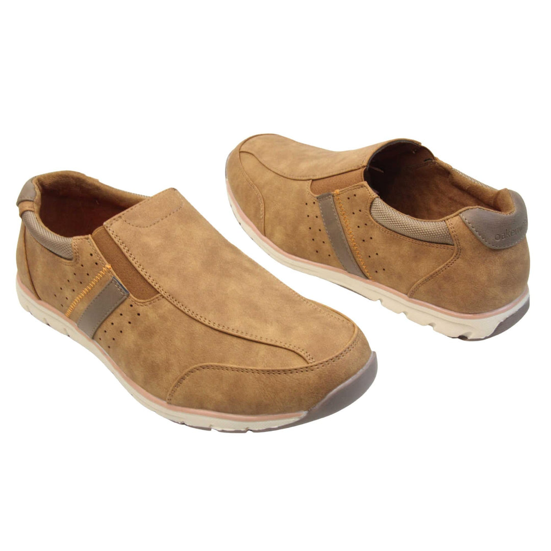 Tan trainers mens. Slip on trainers with tan faux suede uppers. Elasticated side gussets in brown and a dark brown diagonal stripe to the side of the shoe. Brown collar around the neck of the shoe with Oakenwood branding to the heel. Tan lining and a white outsole with grey sole. Both feet at an angle facing top to tail.
