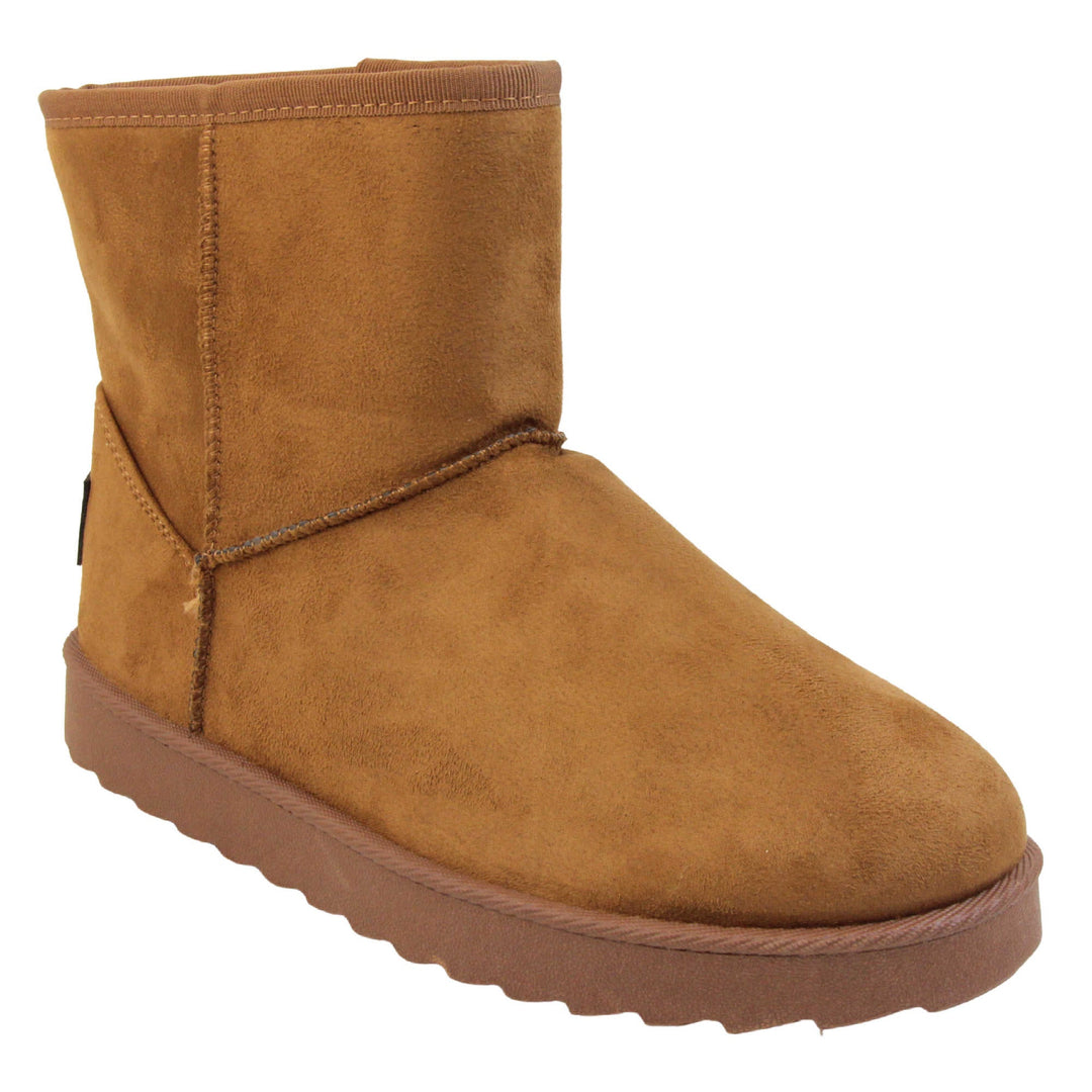 Tan winter boots women's. Ankle boots with a tan faux suede upper and stitching detail. Brown faux fur lining. Chunky brown sole with deep tread to the bottom. Right foot at an angle.