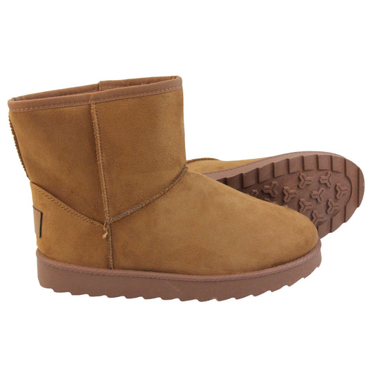 Tan winter boots women's. Ankle boots with a tan faux suede upper and stitching detail. Brown faux fur lining. Chunky brown sole with deep tread to the bottom. Both feet from a side profile with the left foot on its side to show the sole.