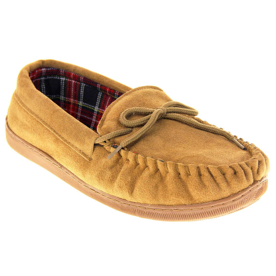 Tartan slippers. Moccasin style slipper with tan suede upper and leather bow to the top. Blue and red tartan plaid lining. Beige synthetic sole. Right foot at an angle.