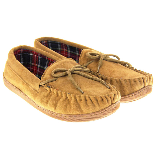 Tartan slippers. Moccasin style slipper with tan suede upper and leather bow to the top. Blue and red tartan plaid lining. Beige synthetic sole. Both feet together at an angle.