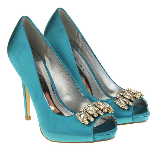 Teal wedding shoes. Classic women's peep toe high heels with a teal satin upper. Metallic silver insole with Sabatine branding. Teal satin stiletto heel with a cream sole. Diamante cluster detailing across the toes. Both feet together at a slight angle.