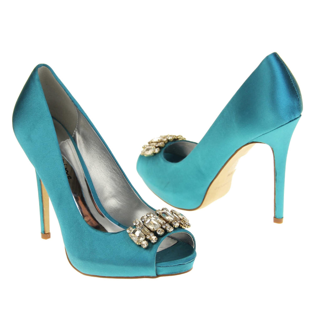 Teal wedding shoes. Classic women's peep toe high heels with a teal satin upper. Metallic silver insole with Sabatine branding. Teal satin stiletto heel with a cream sole. Diamante cluster detailing across the toes. Both feet at an angle facing top to tail.
