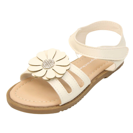 Toddler girl flower sandal. Strappy sandals with white faux leather strappy upper. With around the ankle strap with hook and loop fastening. White flower detailing to the front of the shoe with a diamante middle. Beige coloured insole with Skyrocket branding in white. Brown sole with grip to the bottom. Left foot at an angle.