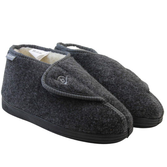 Orthopaedic slippers. Mens orthopaedic slippers in an ankle boot style. With a grey felt upper and white fleece lining. With an adjustable touch close top with a grey Dunlop logo on. Small grey label to the outer side edge with Dunlop written on. Thick black outdoor sole.  Both feet together at an angle.