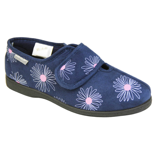 Washable slippers womens. Ladies full back slipper. Navy blue upper with white daisy design and bright pink for the middle of the flowers. Touch fasten strap over the top of the foot to adjust the fit. Matching blue textile lining and sole. Right foot at an angle.