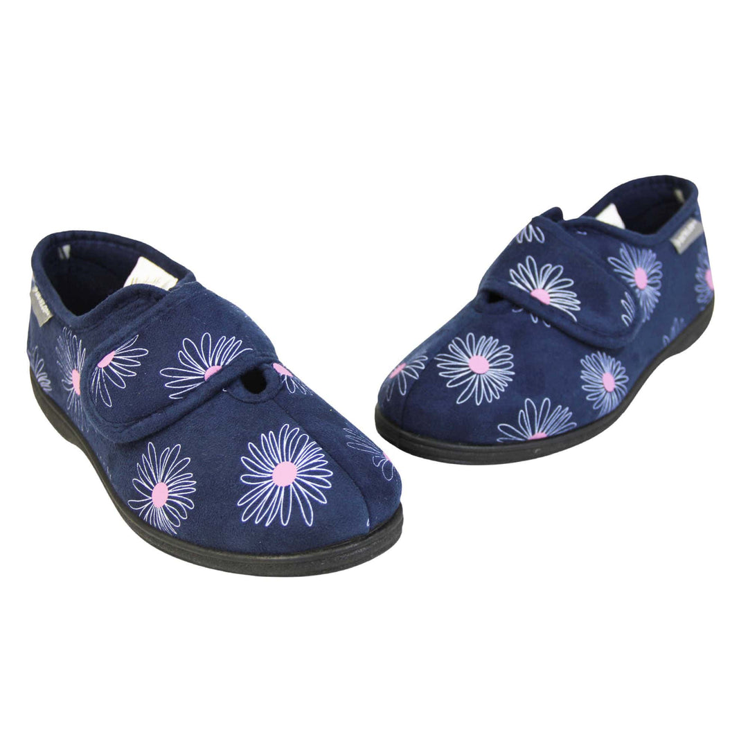 Washable slippers womens. Ladies full back slipper. Navy blue upper with white daisy design and bright pink for the middle of the flowers. Touch fasten strap over the top of the foot to adjust the fit. Matching blue textile lining and sole. Both feet in a V shape with toes almost touching.