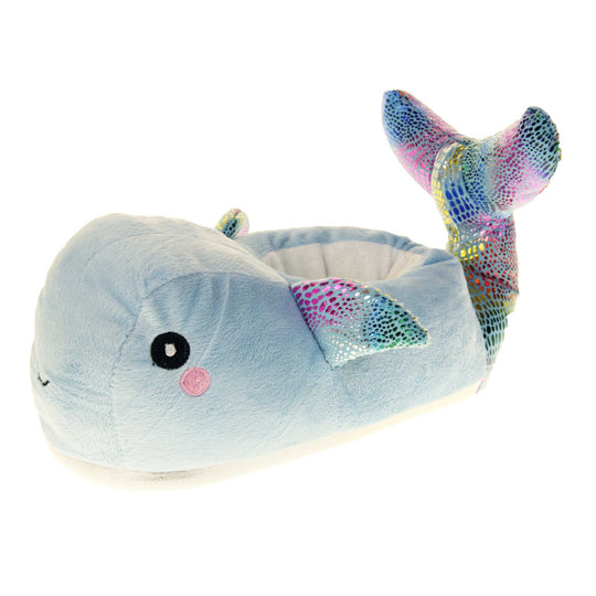 Whale slippers. Womens padded slippers shaped like a whale. With a pale blue body and head. Metallic rainbow fins and tail. Left foot at an angle.