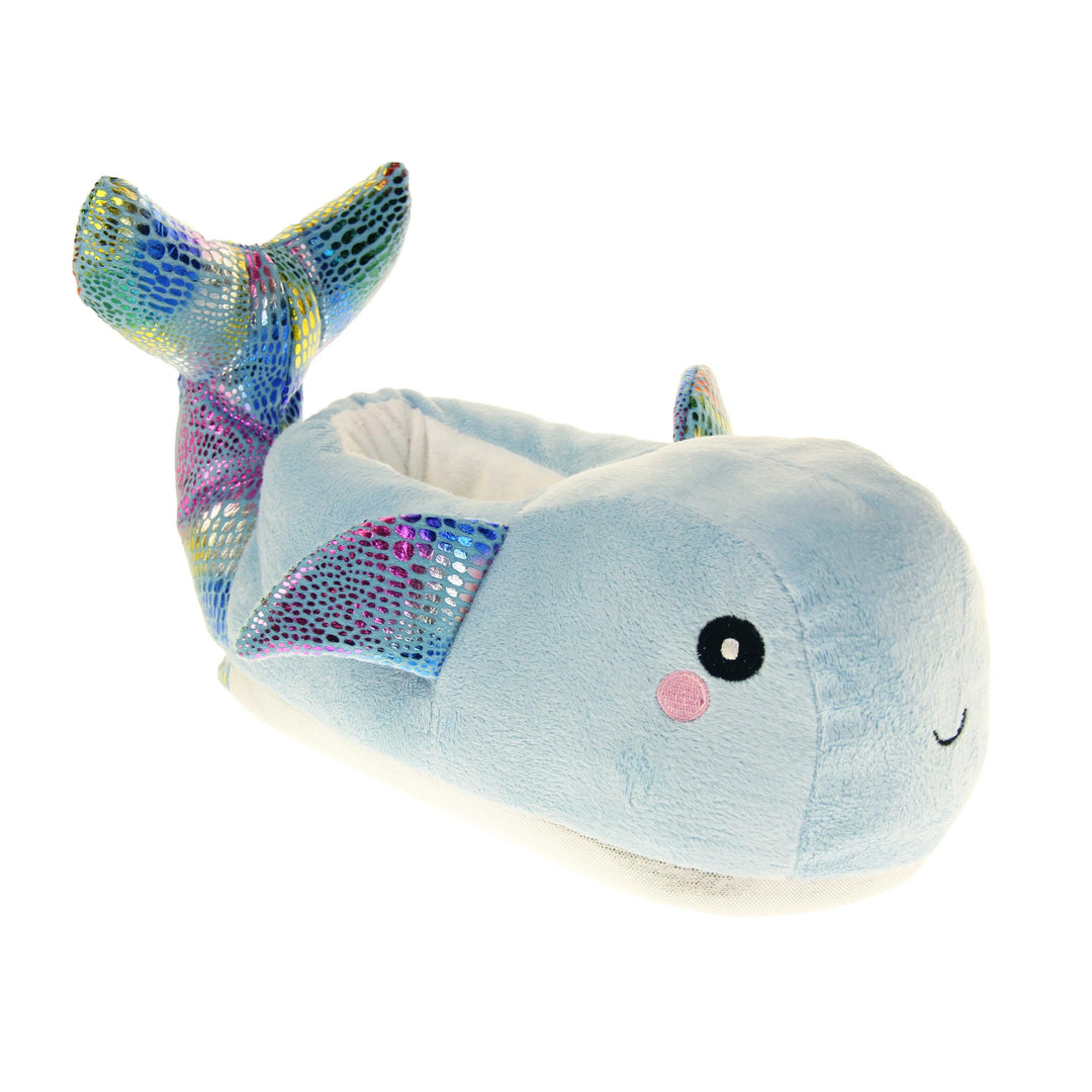 Whale slippers. Womens padded slippers shaped like a whale. With a pale blue body and head. Metallic rainbow fins and tail. Right foot at an angle.