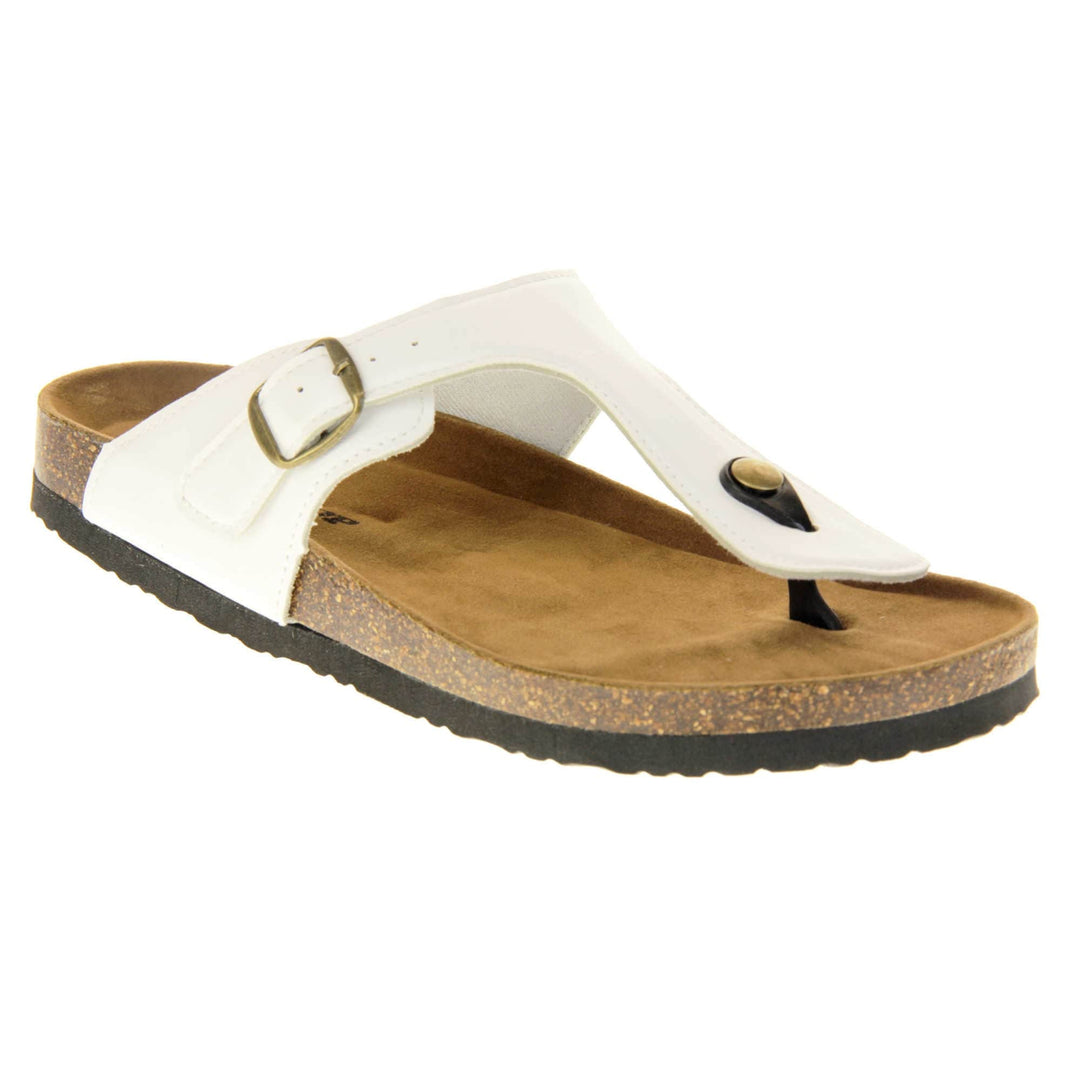 White toe post sandals. White faux leather strap with toe post to the front and gold buckle to the outside. Soft tan faux suede footbed with cork effect outsole and black sole. Right foot at an angle.