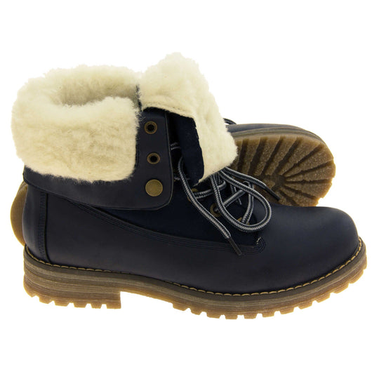 Winter boots women. Navy blue smooth leather upper with lace up fastening and eyelets, welted outsole and wool lining to boot and cuff. Both feet from a side profile with the left foot on its side to show the sole.