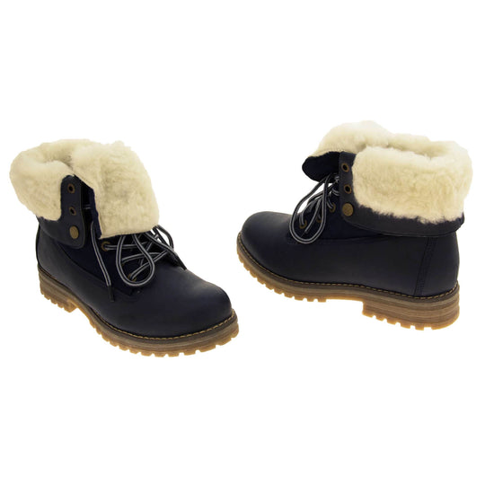 Winter boots women. Navy blue smooth leather upper with lace up fastening and eyelets, welted outsole and wool lining to boot and cuff. Both feet at a slight angle facing top to tail.