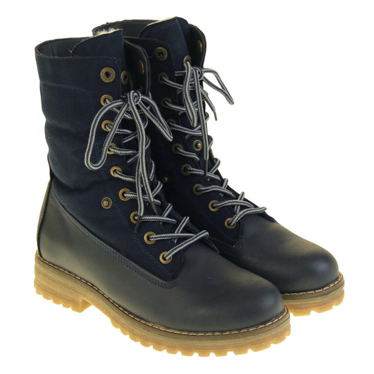 Winter boots women. Navy blue smooth leather upper with lace up fastening and eyelets, welted outsole and wool lining to boot and cuff. Both feet at an angle with cuff raised.