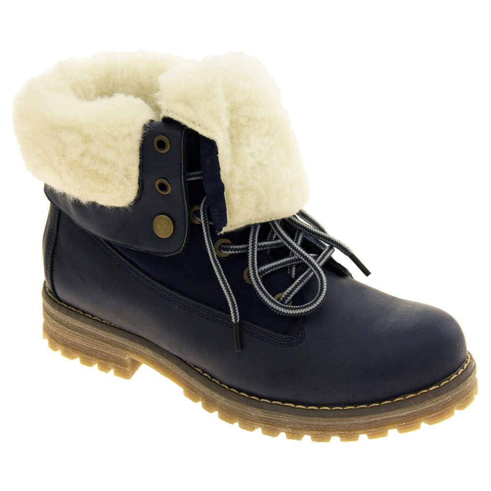 Winter boots women. Navy blue smooth leather upper with lace up fastening and eyelets, welted outsole and wool lining to boot and cuff. Right foot at angle.