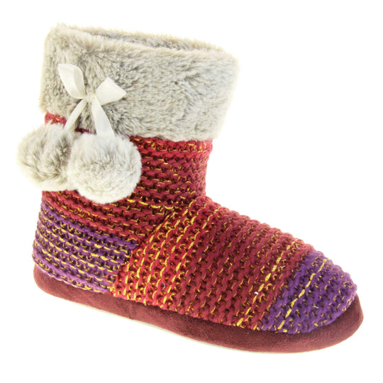 Womens knit slippers. Boot style slippers in a knit upper. Plum fading purple ombre effect with gold thread detailing. Light grey faux fur collar and lining with matching pom poms to the side. Right foot at an angle.