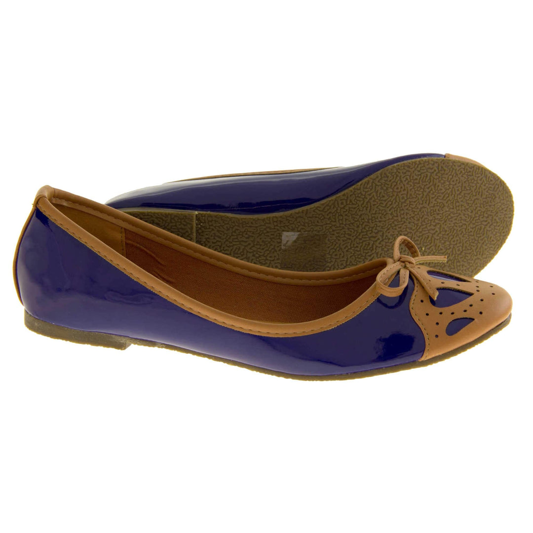 Women's ballet flats. Blue patent leather effect ballet pumps with brown faux leather collar and detailing to the toe. Brown sole with a very slight heel. Both feet from a side profile with the left foot on its side to show the sole.