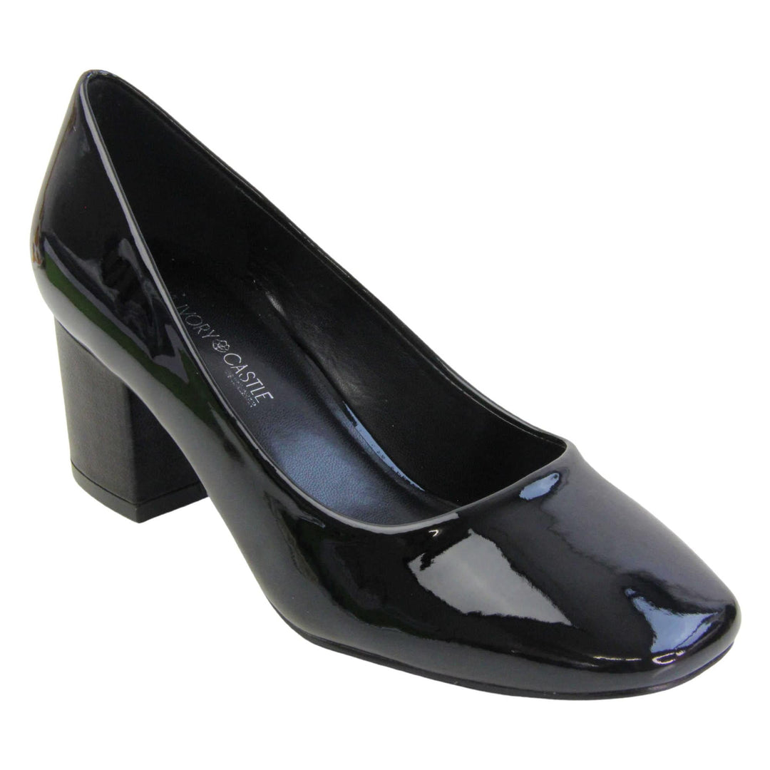 Womens black block heel. Womens court shoes with black patent faux leather uppers. Black block heel. Black faux leather lining with beige textile lining at the heel. Beige sole. Right foot at an angle.