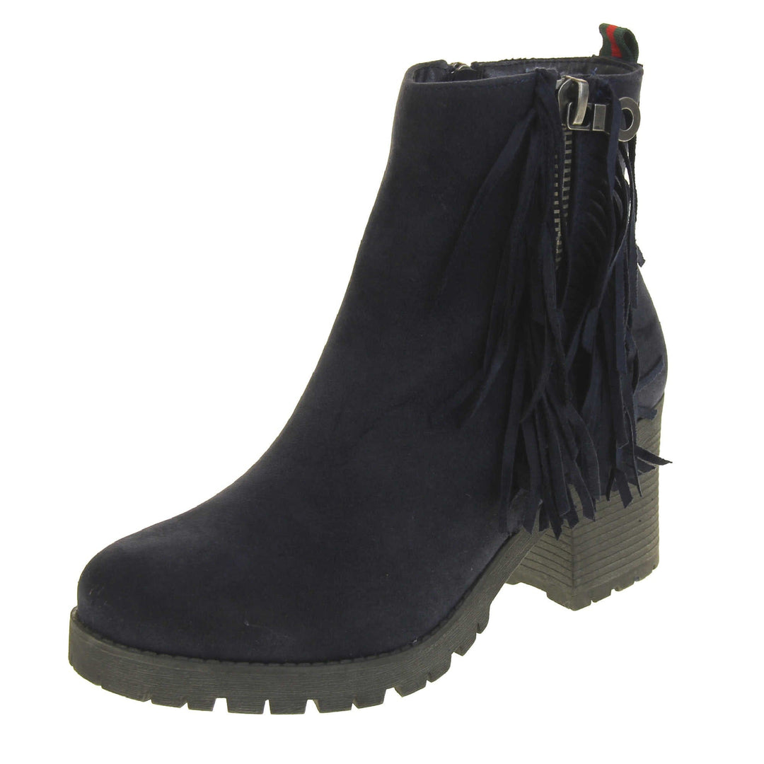 Women's fur lined winter boots. With a navy blue suede upper and zip fastening to the inside of the shoe. Decorate zip fastening to the outside with tassel detailing down the sides of the zip. Navy faux fur lining. A loop at the heel to help pull them on. Black outsole with chunky block heel. Left foot at an angle.
