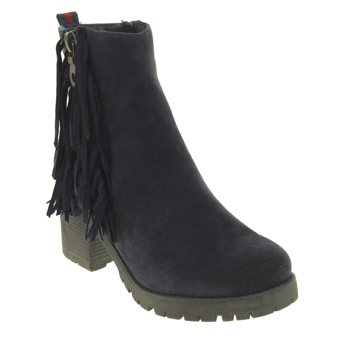 Women's fur lined winter boots. With a navy blue suede upper and zip fastening to the inside of the shoe. Decorate zip fastening to the outside with tassel detailing down the sides of the zip. Navy faux fur lining. A loop at the heel to help pull them on. Black outsole with chunky block heel. Right foot at an angle.